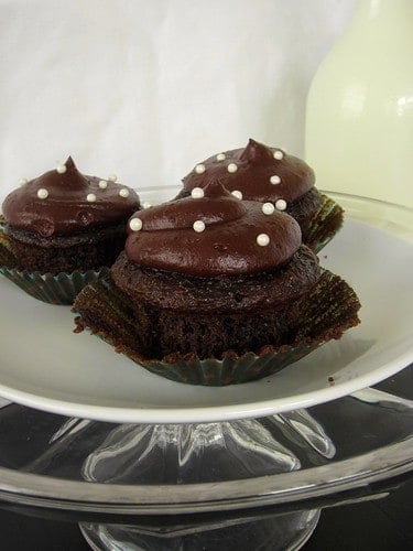 Side view of three Chocolate Cream Cheese Cupcakes on a plate