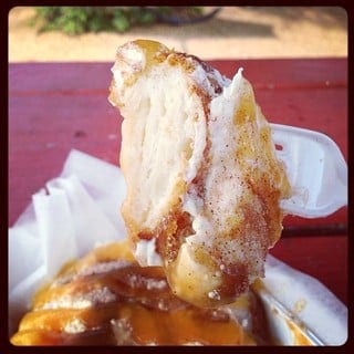 Close-up of Son of a Peach doughnut from Gourdough's with a bite on a fork