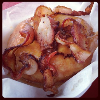 Close-up of Flying Pig Maple Bacon donut from Gourdough's