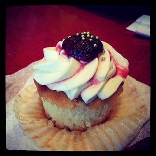 An unwrapped Raspberry Champagne Cupcake from Delish bakery