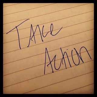 Take Action written on lined paper