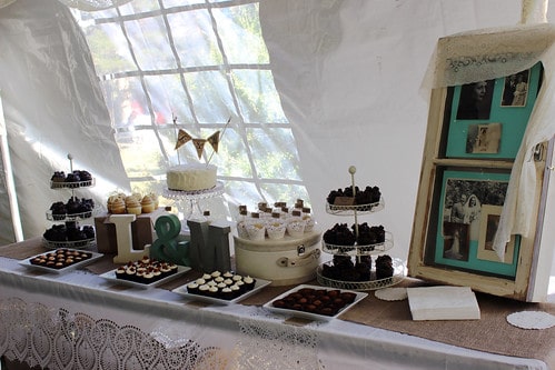 A variety of wedding cakes and cupcakes on a table