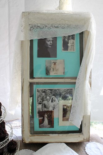 A collage frame of old family photos draped in lace