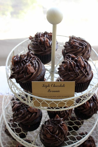 Triple chocolate brownie cupcakes on a cake stand