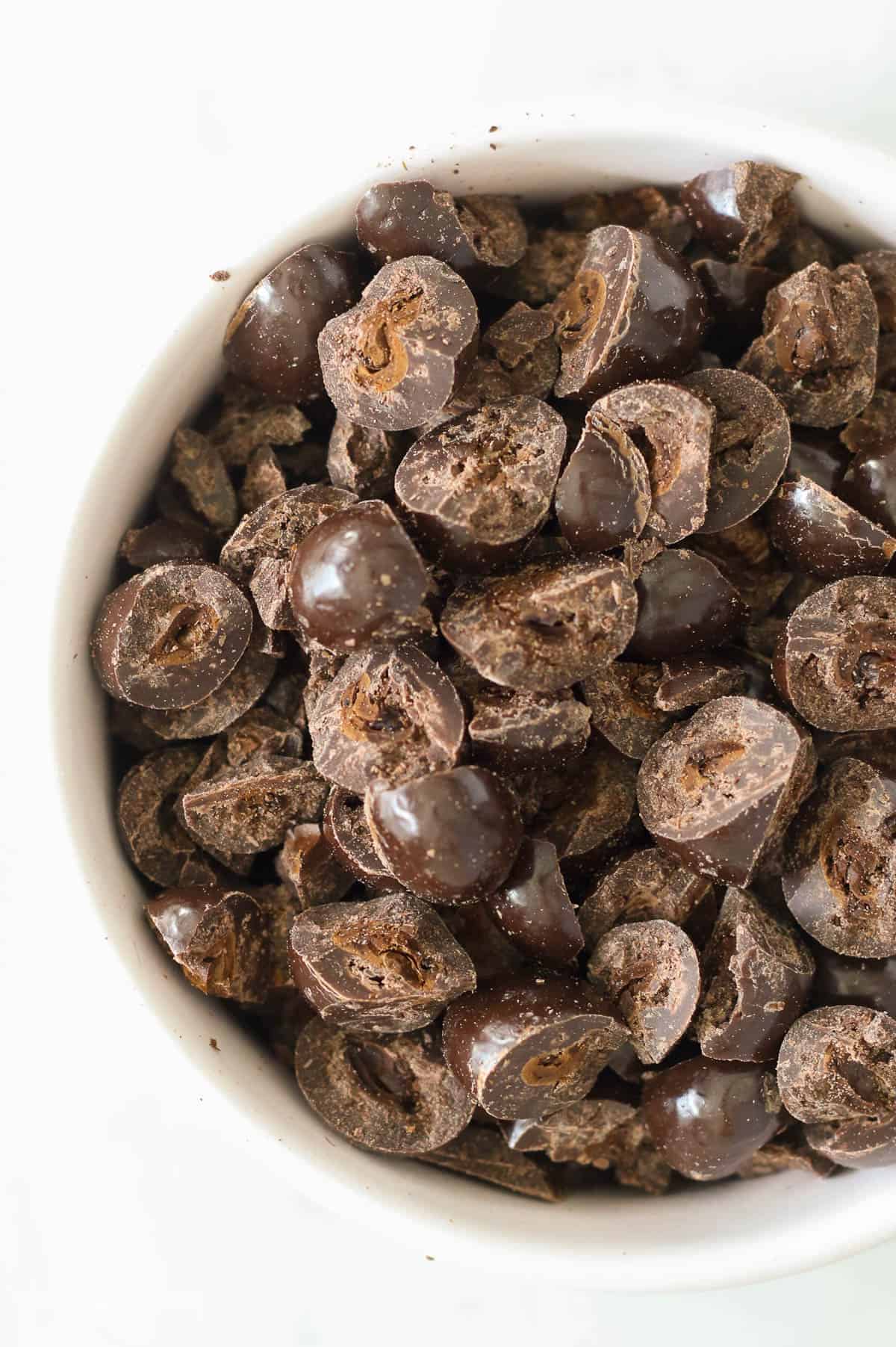 Choppedchocolate covered espresso beans in a white bowl