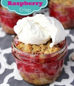 Jars full of Gluten-Free Raspberry Crisp served with a scoop of ice cream on top.