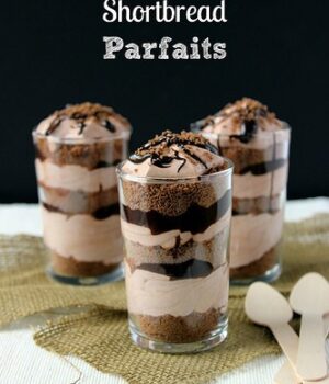 Three Chocolate Shortbread Mousse Parfaits with layers of chocolate shortbread cookies, chocolate mousse, and chocolate ganache.