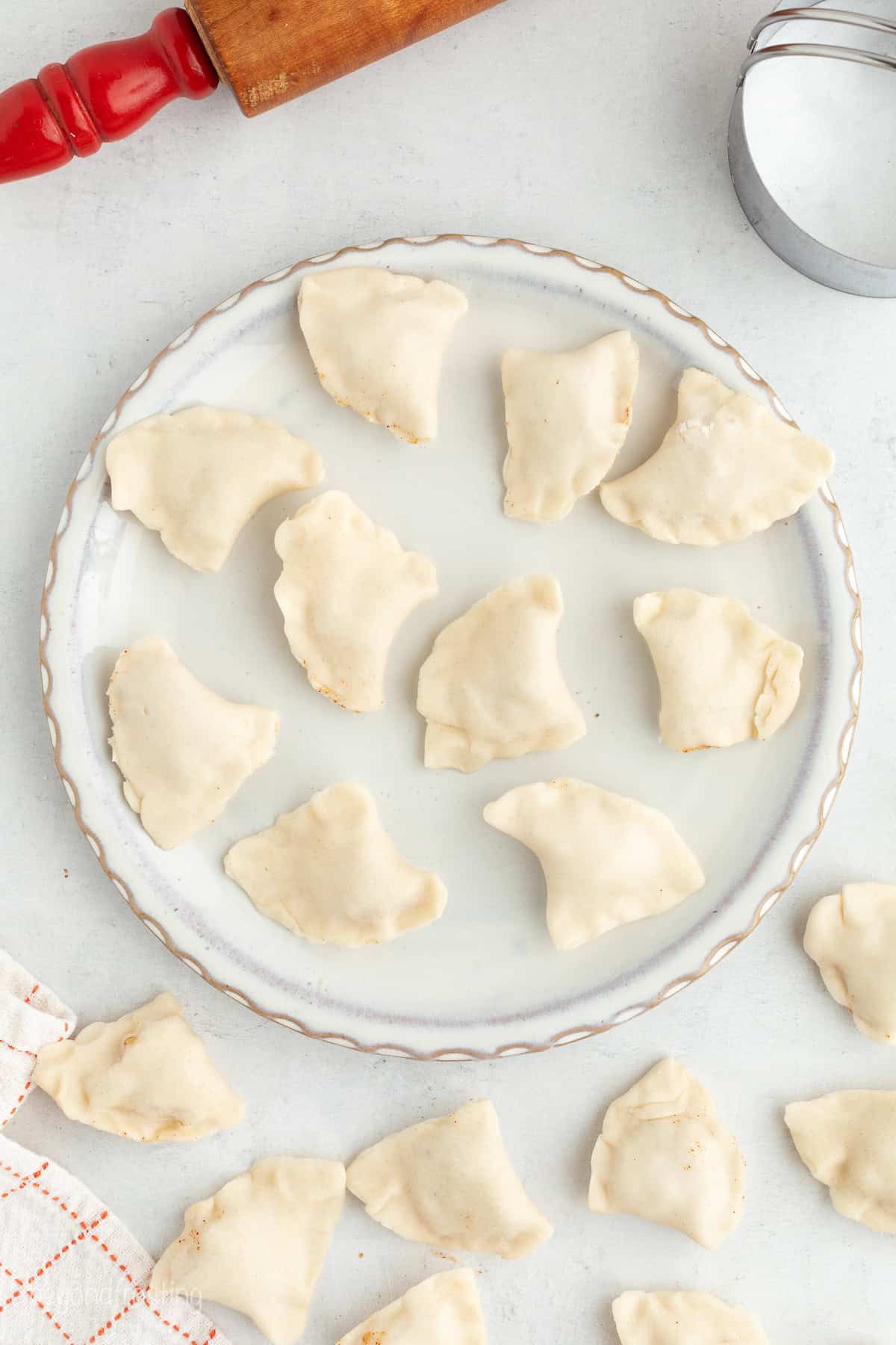 Golden-fried apple pie bites are easy to make, with refrigerated pie dough and gooey homemade apple pie filling. Like bite-sized apple pies! Sealed apple pie bites on a plate.