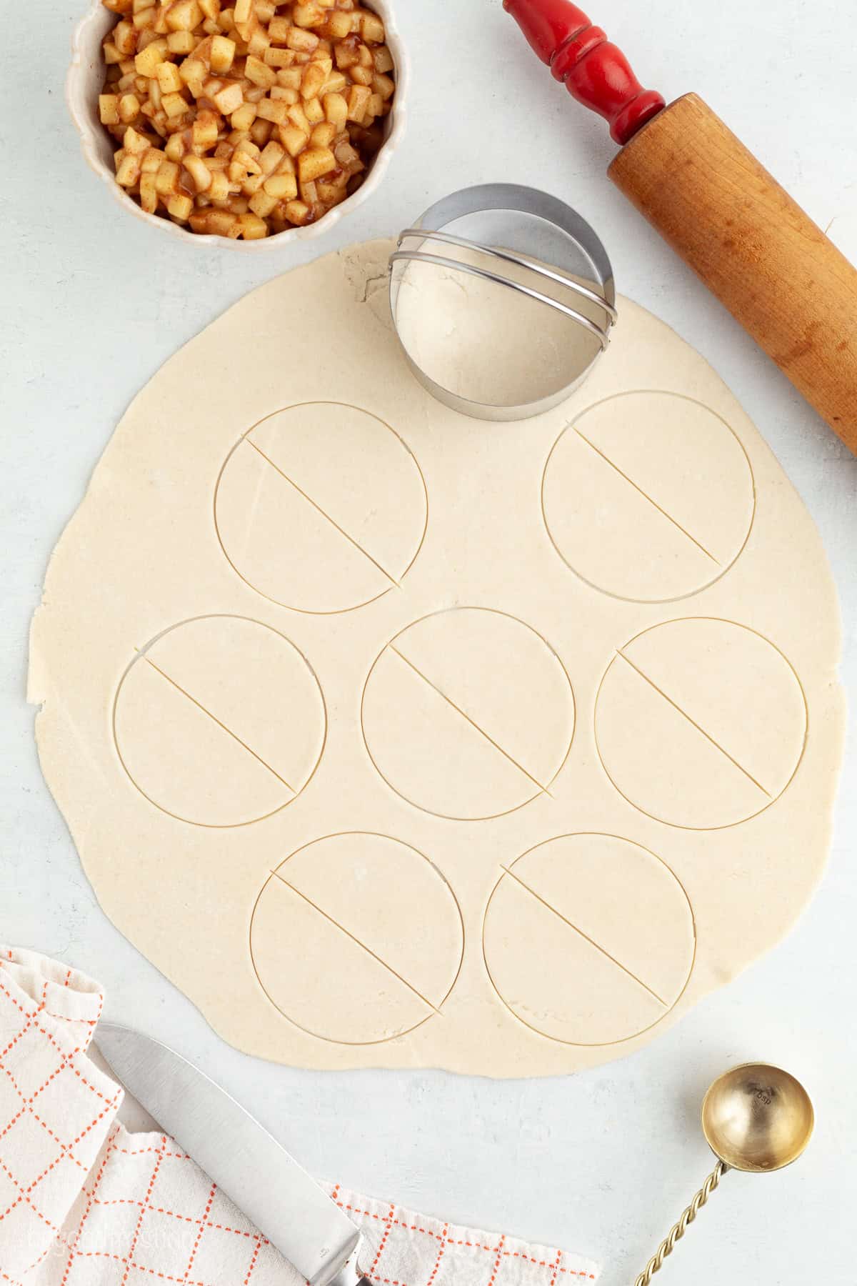 Golden-fried apple pie bites are easy to make, with refrigerated pie dough and gooey homemade apple pie filling. Like bite-sized apple pies! Rolled out refrigerated pie dough cut into circles using a round biscuit cutter.
