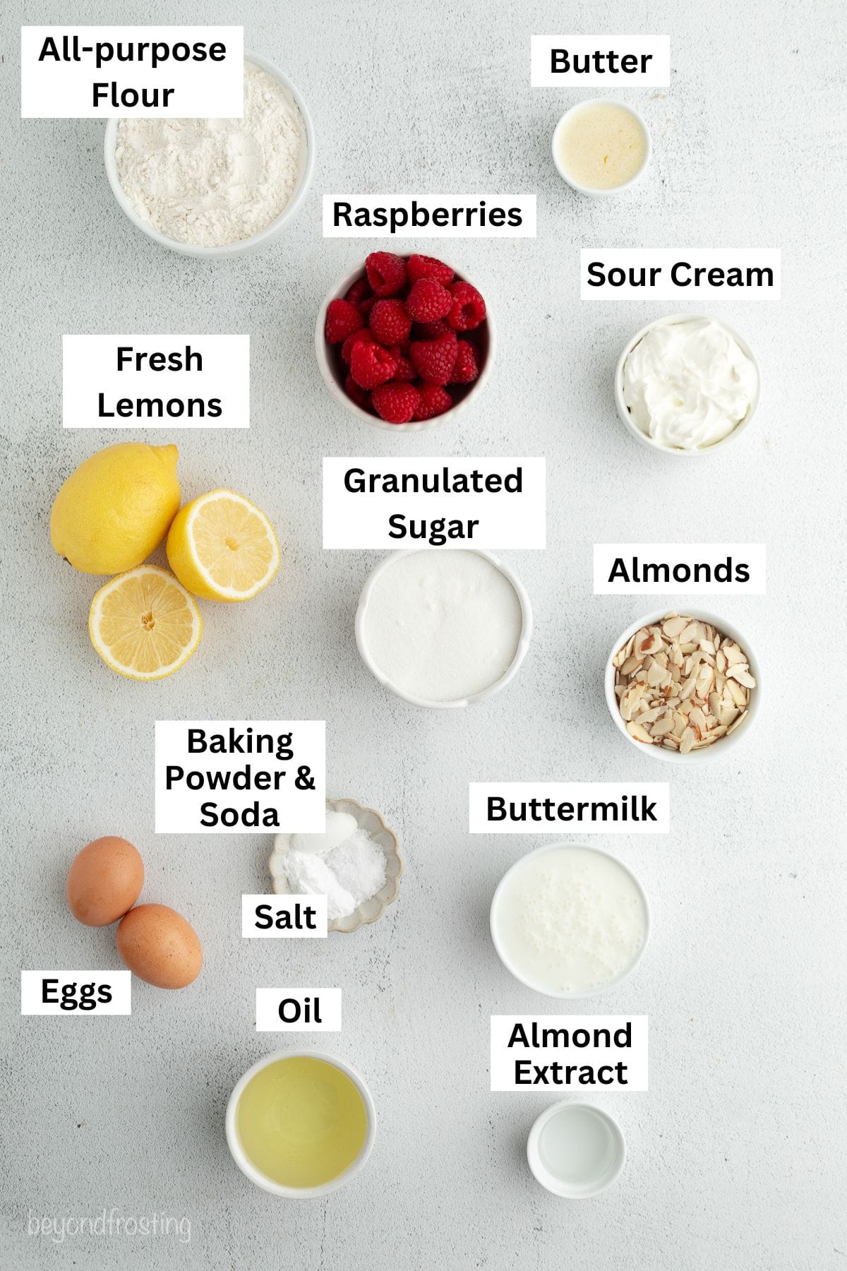 Almond raspberry muffins ingredients with text labels overlaying each ingredient.