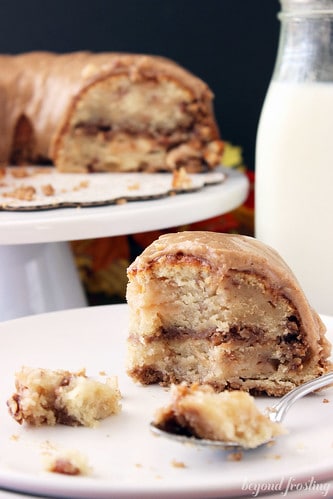 Apple Pie Coffee Cake slice on a plate with a bite on a fork
