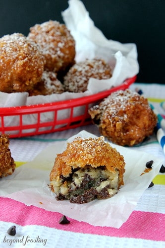 Deep fried cookie dough bites in and around a plastic basket
