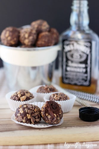 Whiskey Chocolate Toffee Truffles in paper dessert cups with a bite out of one