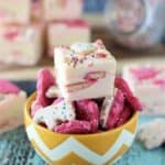 a bowl of circus animal cookies with a piece of fudge on top