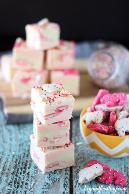 A stack of Circus Animal Fudge next to a bowl of Circus Animal Cookies