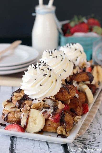 A tray full of Donut Dessert Nachos topped with whipped cream.