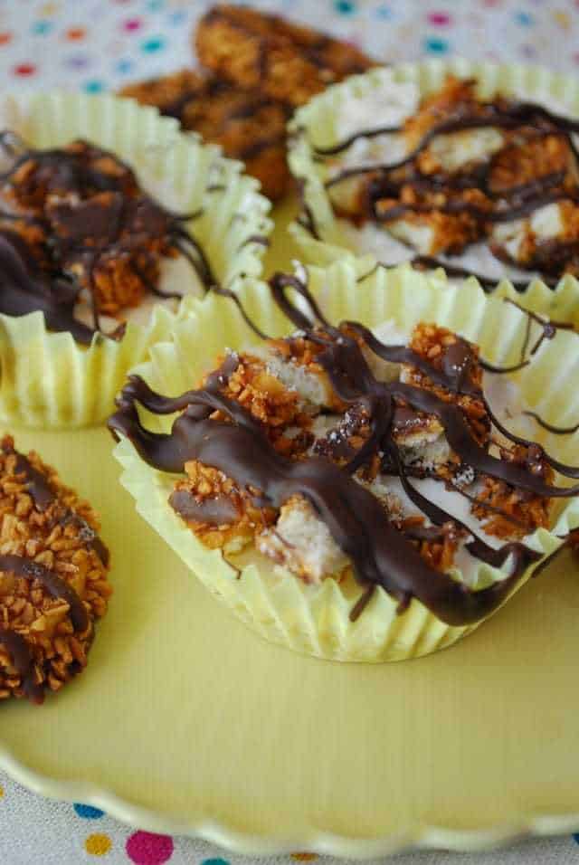 Mini Samoa Cheesecakes in Yellow Cupcake Liners on a Yellow Plate