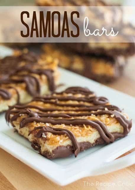 Two Samoa Bars on a White Serving Platter in Front of a Loose Pile of Bars