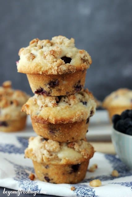 3 Coconut Blueberry Muffins stacked on a blue and white napkin