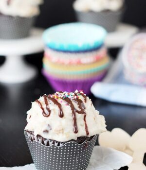 A chocolate cupcake topped with Hot Fudge Sundae Frosting and a drizzle of chocolate sauce.