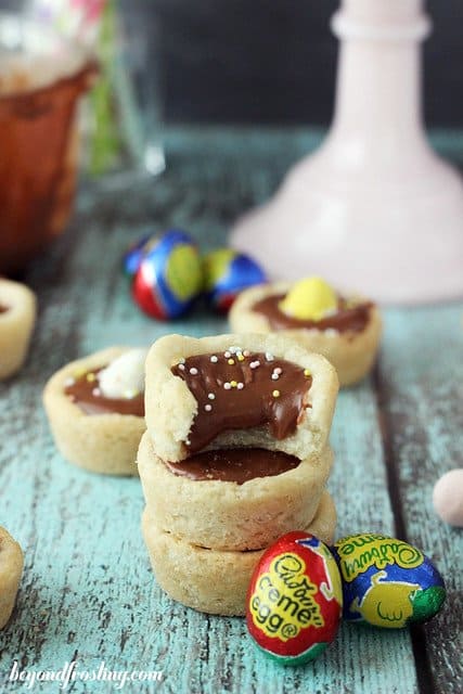 Cadbury Ganache Cookie Cups stacked with a bite out of the top one