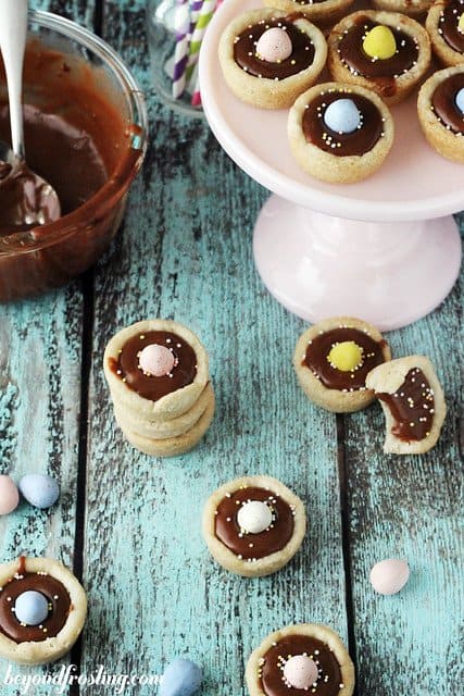 Overhead view of Cadbury Ganache Cookie Cups on a cake stand and around it