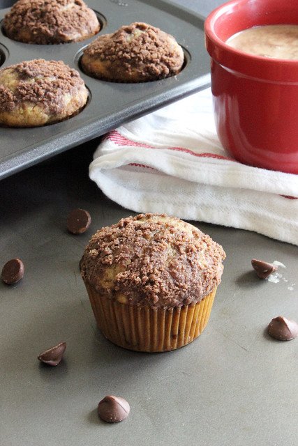 A Chocolate Zucchini Muffin in front of a tin of muffins