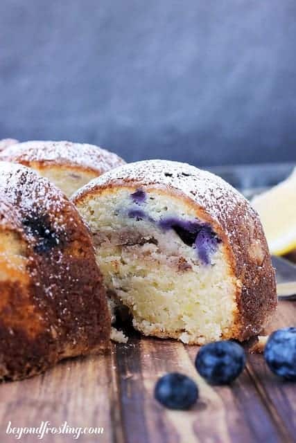 Photo of a slice of Lemon Blueberry Bundt Cake being removed from the cake