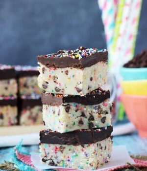 3 pieces of Funfetti Cookie Dough Truffle Bars stacked.