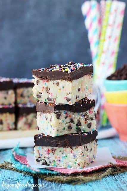 3 pieces of Funfetti Cookie Dough Truffle Bars stacked.