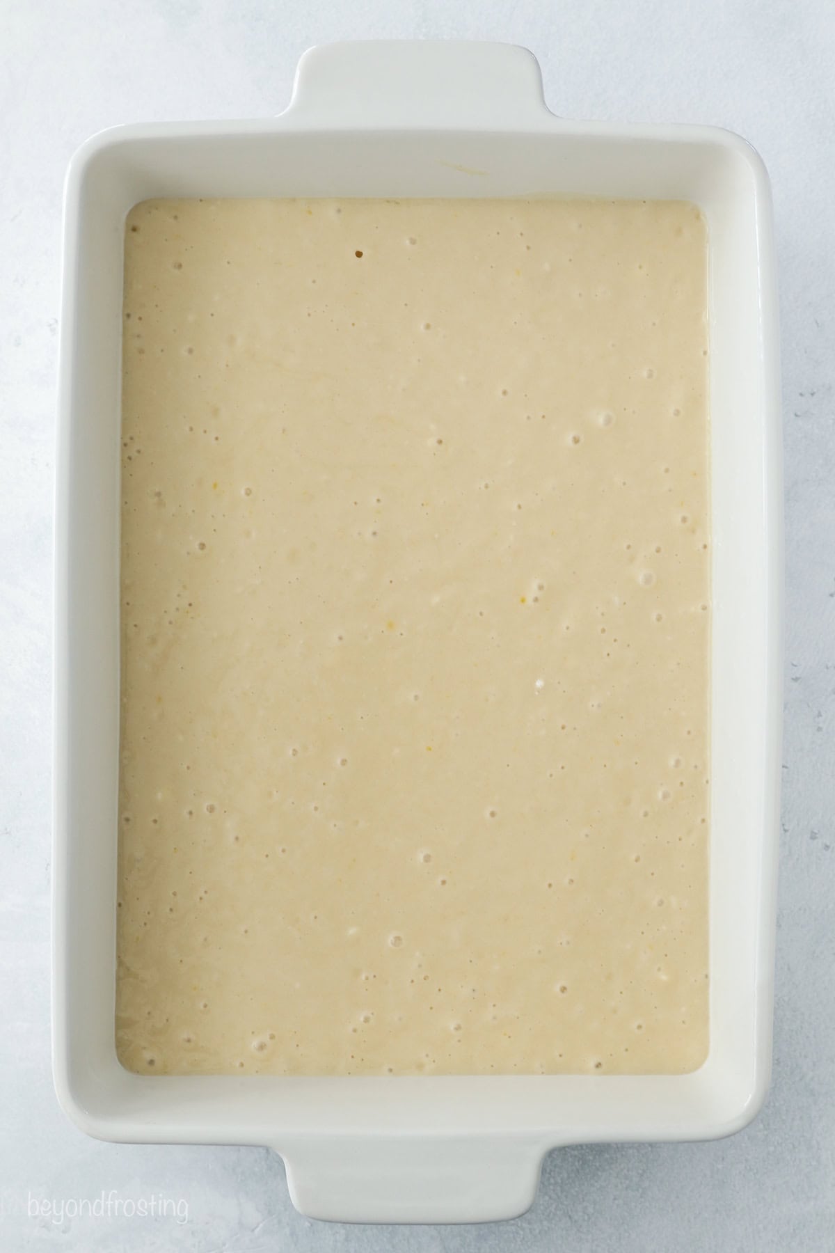 Cake batter in a 9x13 baking dish.