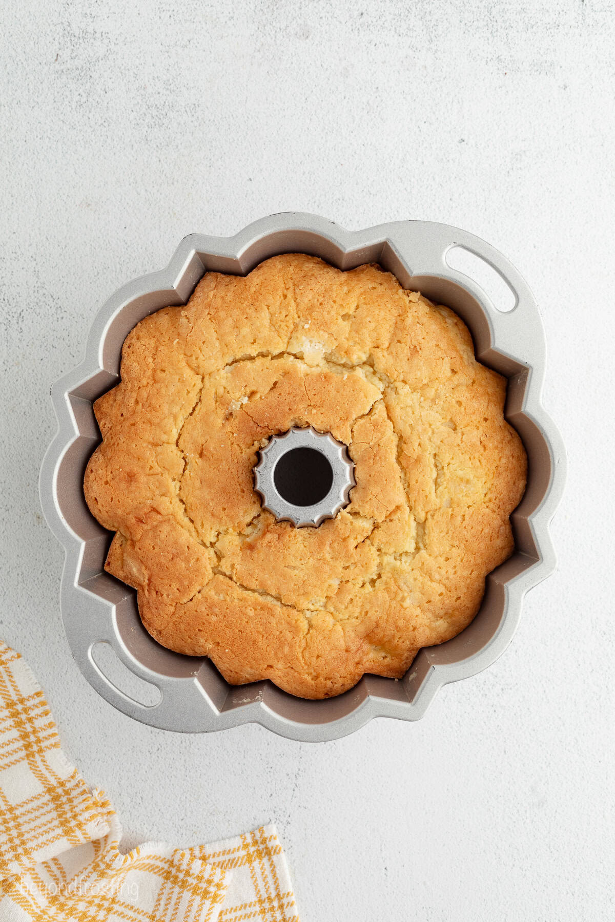 Overhead view of a baked bourbon peach pound cake in a bundt pan.