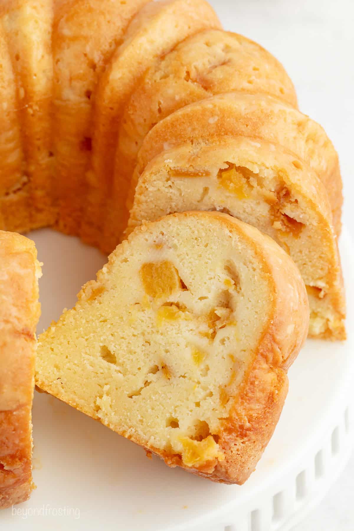 Close up of a bourbon peach pound cake cut into slices.