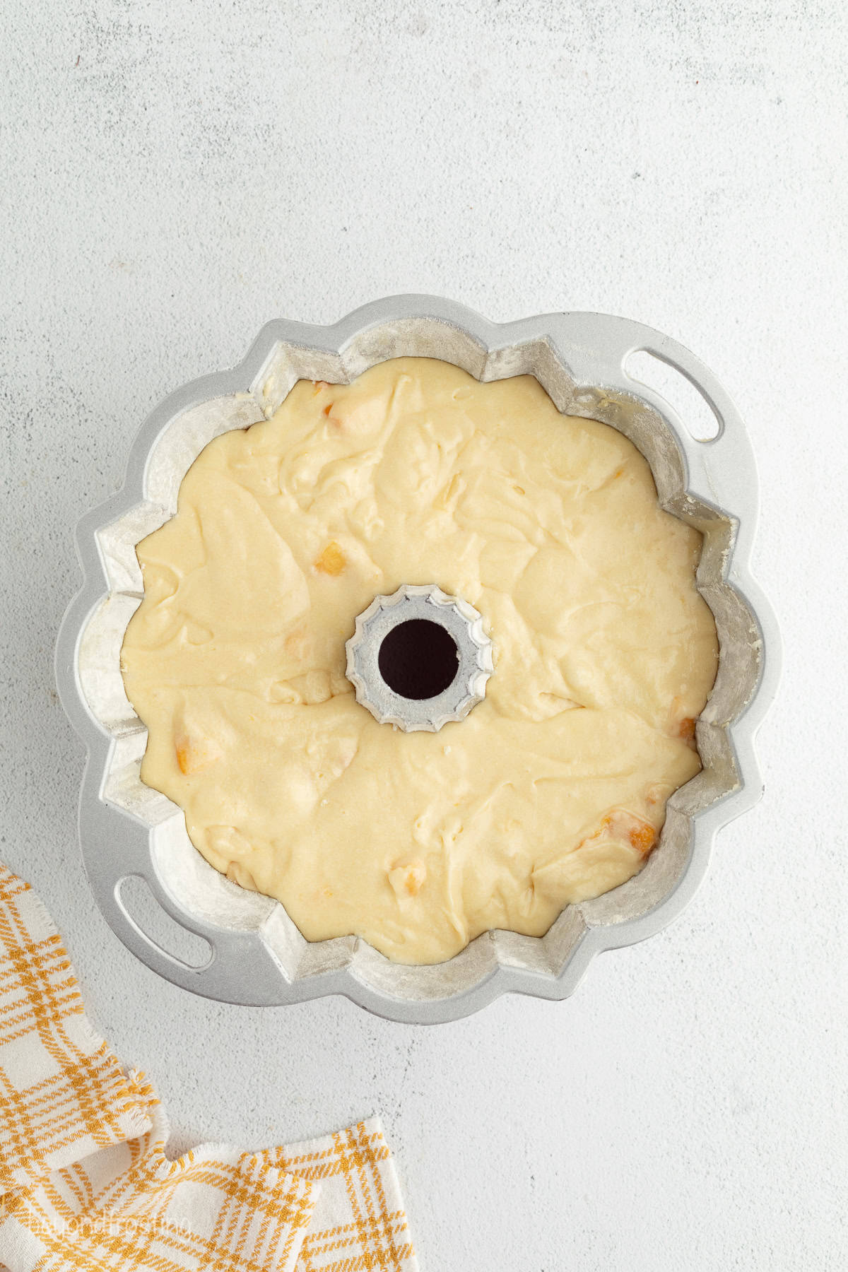 Peach pound cake batter in a bundt pan.