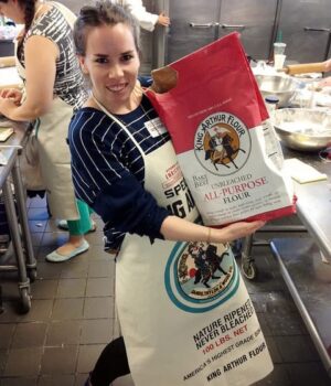 A picture of me holding a huge bag of King Arthur Flour.