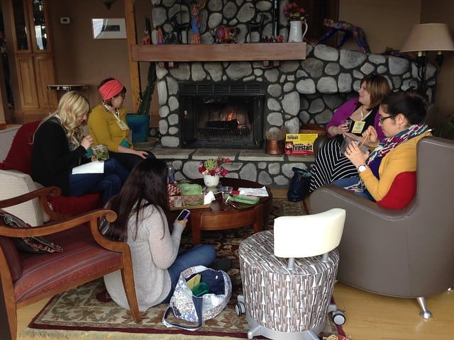 Four food bloggers eating around a fireplace