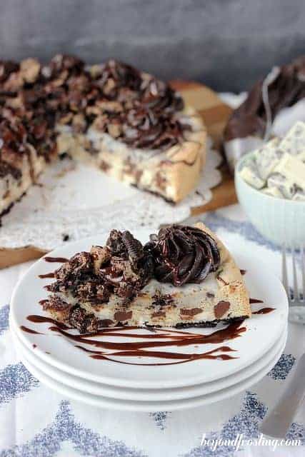 A slice of Double Cookies and Cream Cookie Cake drizzled with chocolate ganache.