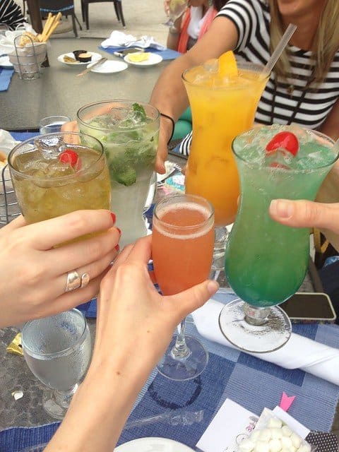 Food bloggers toasting with a variety of cocktails in Miami