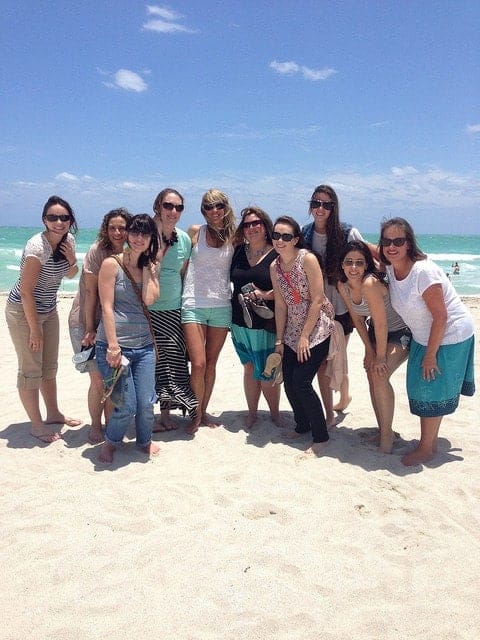 A group of food bloggers posing on the beach in Miami