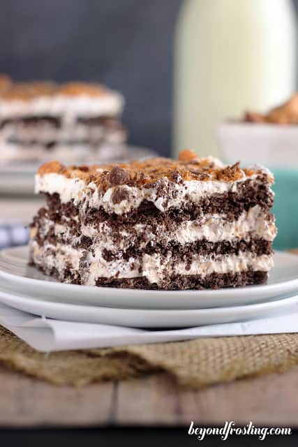 Side view of a square of Butterfinger Icebox Cake on a plate