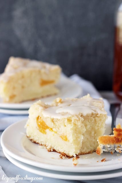Two slices of Bourbon Peach Pound Cake on a plate with a bite on a fork
