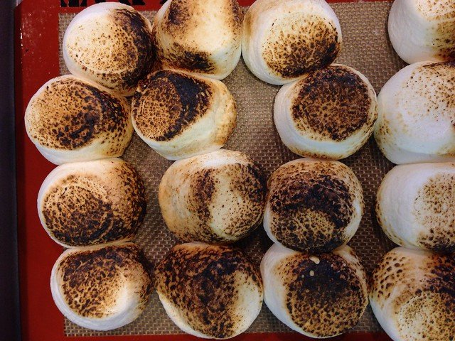 Overhead view of toasted marshmallows on a baking mat