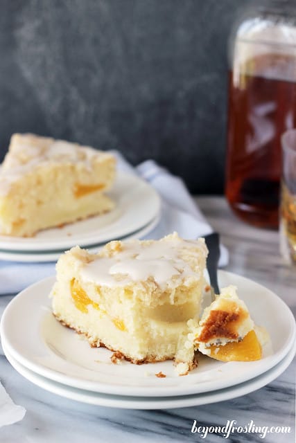 A slice of Bourbon Peach Pound Cake on a plate with a bite on a fork