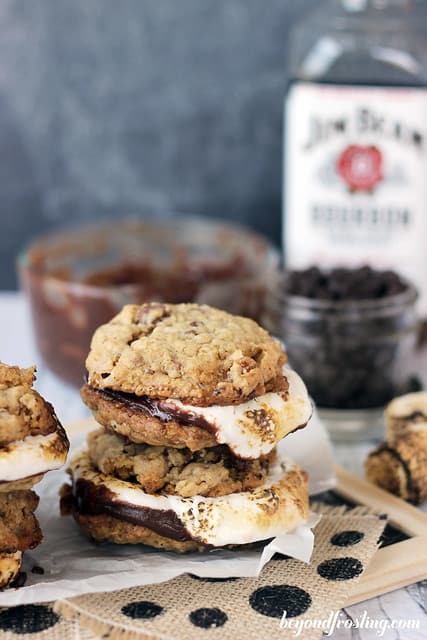 A stack of Bourbon Bacon Smores cookies on burlap in front of ingredients