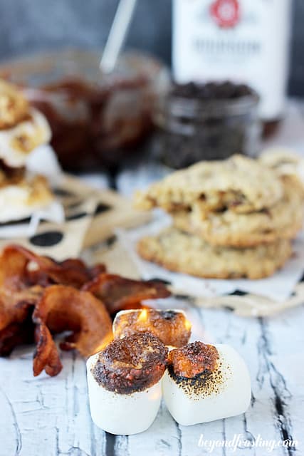 Toasted marshmallows, bacon, and cookies for Bourbon Bacon Smores cookies