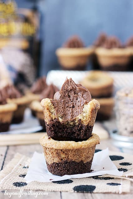 Two stacked Brownie Brittle Toffee Crunch Cookie Cups with a bite removed from the top one