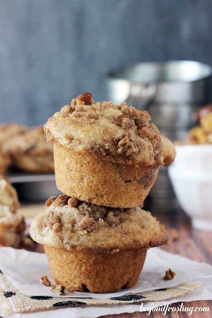 A stack of two apple pie muffins with brown butter pecan streusel on top