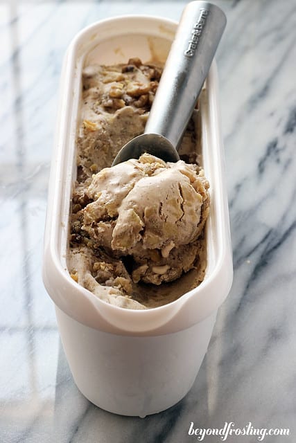 A container of Bourbon Apple Pie ice cream with an ice cream scoop