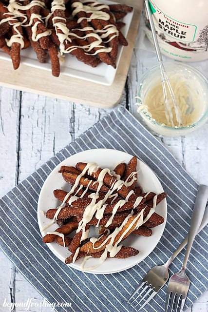 Overhead view of Cinnamon Sugar Donut Fries on a plate with maple glaze