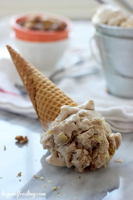 A tipped over sugar cone of Bourbon Apple Pie ice cream